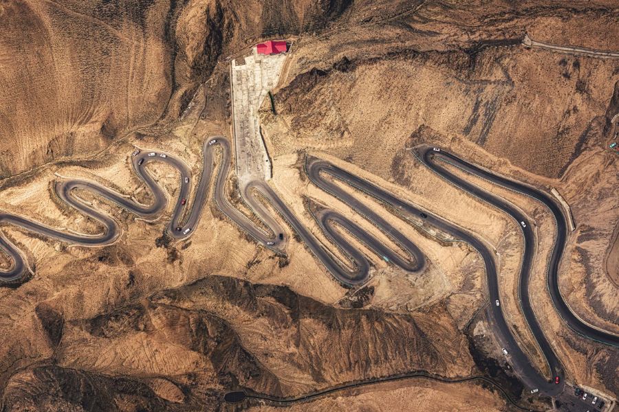 Panlong Ancient Road aerial view with winding mountain road on Pamir Plateau Panlong Ancient Road aerial view with winding mountain road on Pamir Plateau