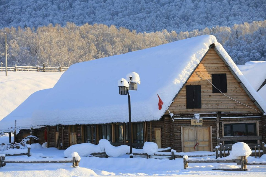Hemu Village winter snow landscape with traditional wooden cabins in Xinjiang