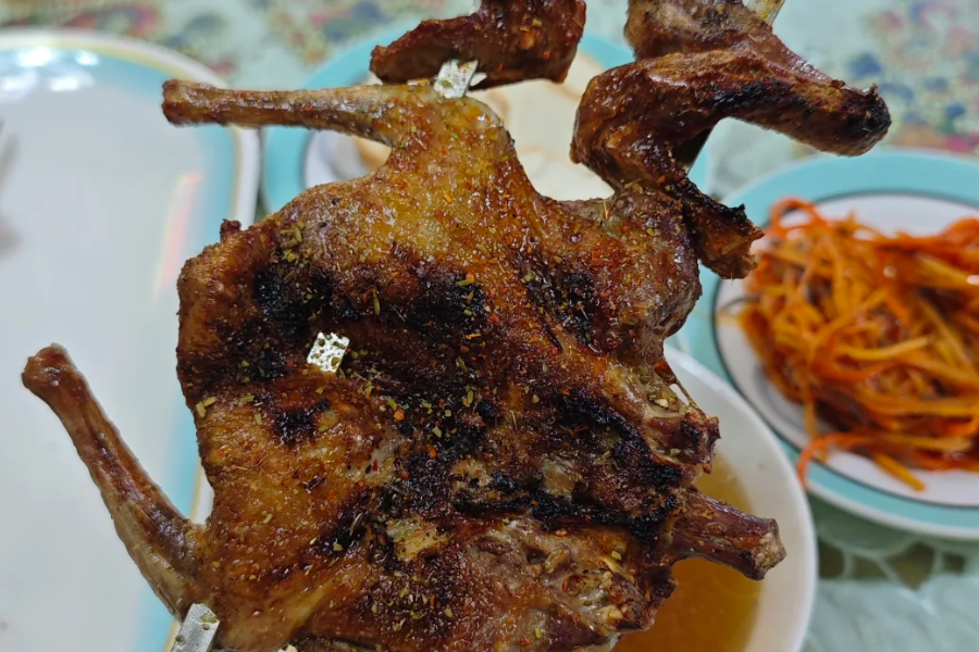Kashgar roast pigeon served at a traditional Xinjiang night food street Kashgar roast pigeon served at a traditional Xinjiang night food street