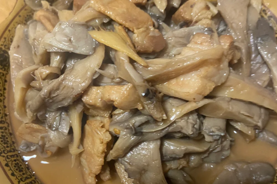Fresh mushrooms, herbs, and ingredients used in mushroom stew preparation including onions, garlic, and cream