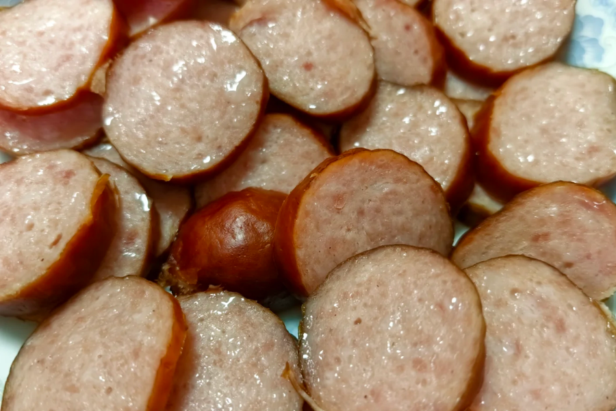 Assorted Russian sausage types including Doctor sausage smoked and salami style kolbasa on wooden board Assorted Russian sausage types including Doctor sausage smoked and salami style kolbasa on wooden board