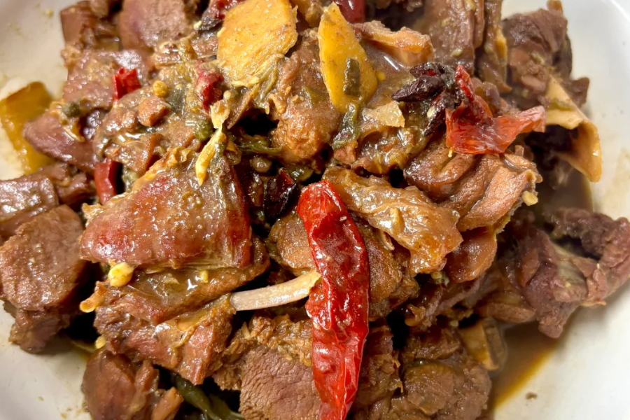 Venison dish served in a traditional Xinjiang restaurant table setting