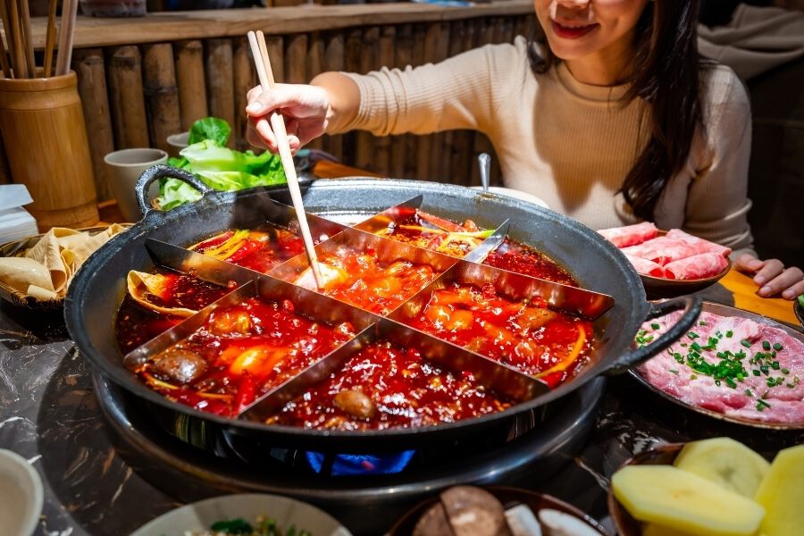 Chengdu hot pot with spicy broth, meat, vegetables, and tofu, Chinese shared dining experience for travelers Chengdu hot pot with spicy broth, meat, vegetables, and tofu, Chinese shared dining experience for travelers