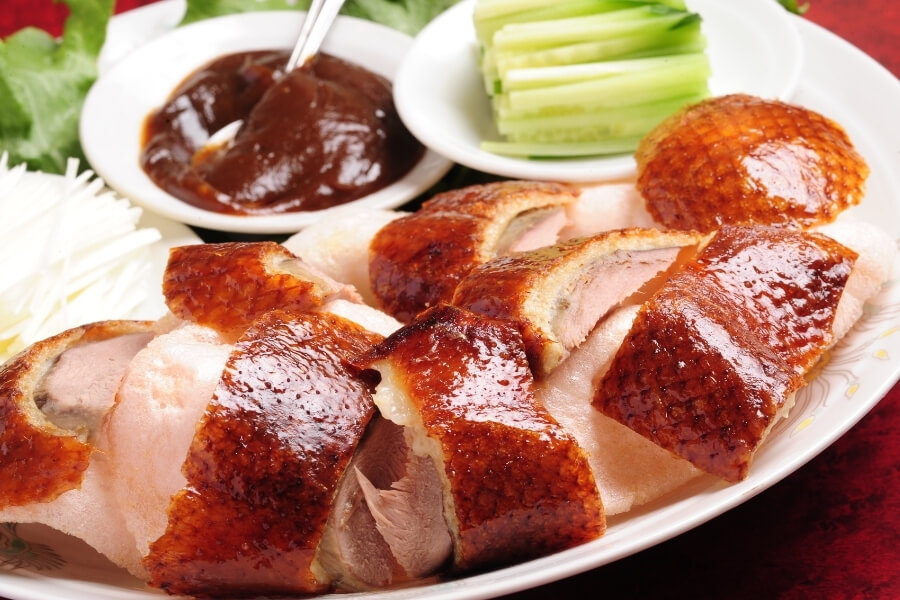Peking duck with pancakes, scallions, cucumber, sweet bean sauce, traditional Chinese cuisine for travelers Peking duck with pancakes, scallions, cucumber, sweet bean sauce, traditional Chinese cuisine for travelers