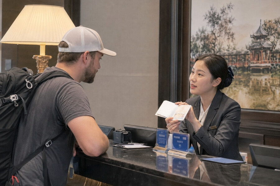 hotel staff confirming Chinese surname order during China travel