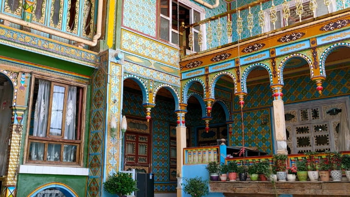 Traveler staying at a traditional Kashgar Old Town homestay courtyard inside Kashgar Old City